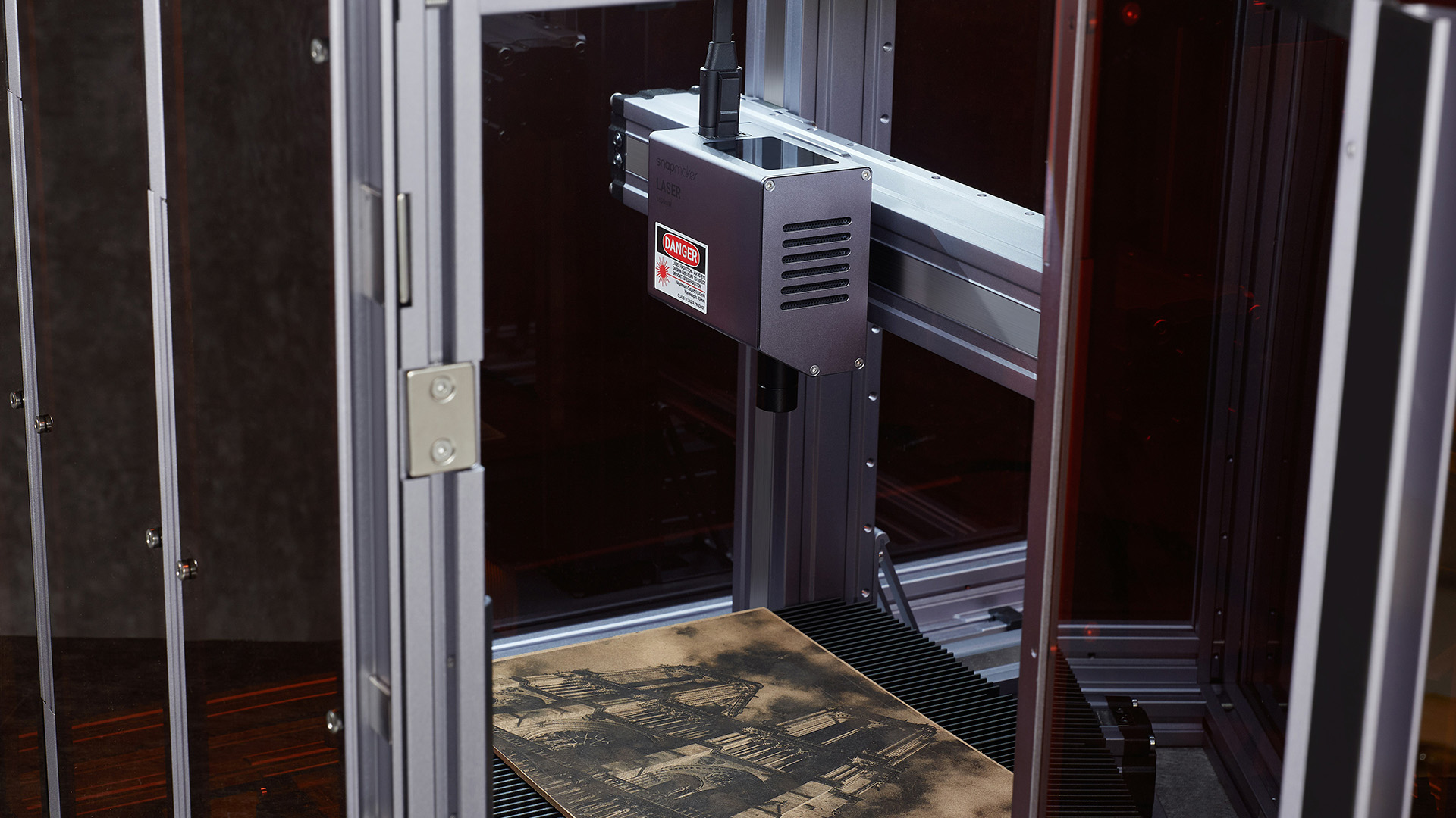 Laser engraving machine used for intricate corporate gift printing on wood, representing premium custom printing service capabilities.