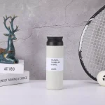 milk custom vacuum flask or travel tumbler in 500ml placed center of books and deer display