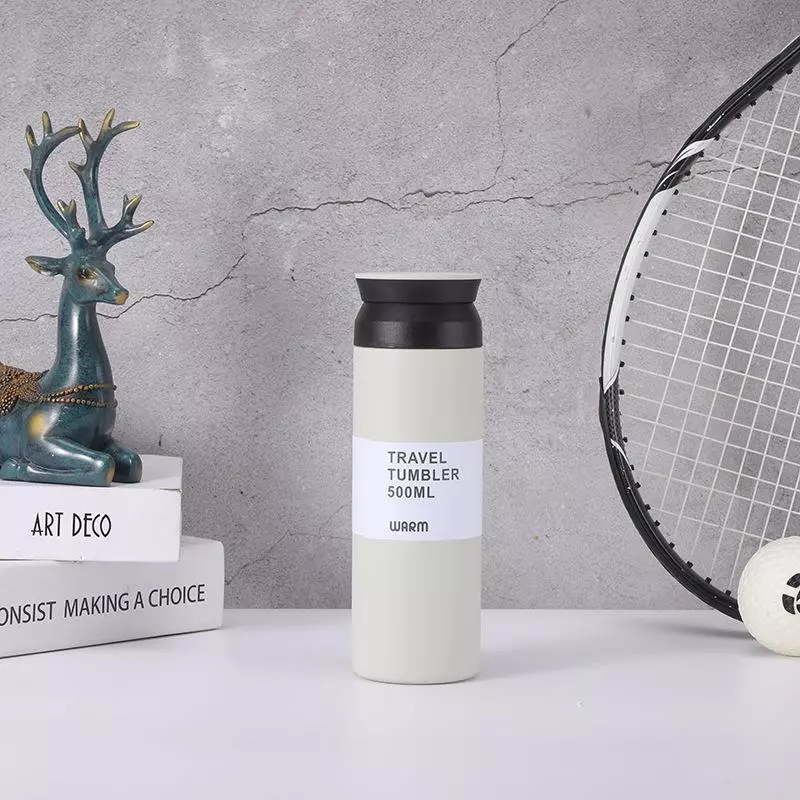 milk custom vacuum flask or travel tumbler in 500ml placed center of books and deer display